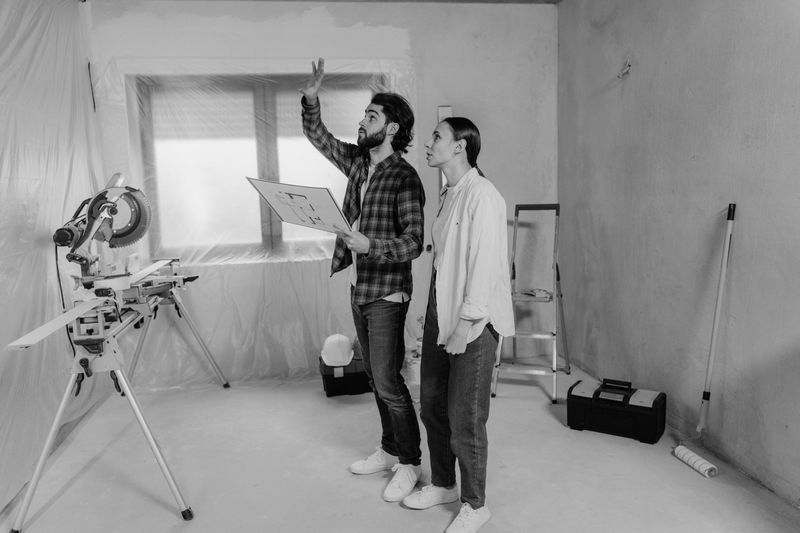 a contractor showing the client his renovation plan